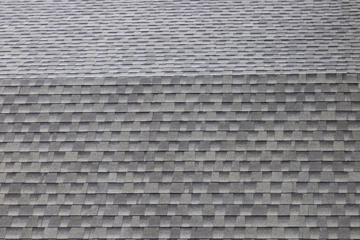 wet roof shingles background and texture. angle slop of asphalt roof.